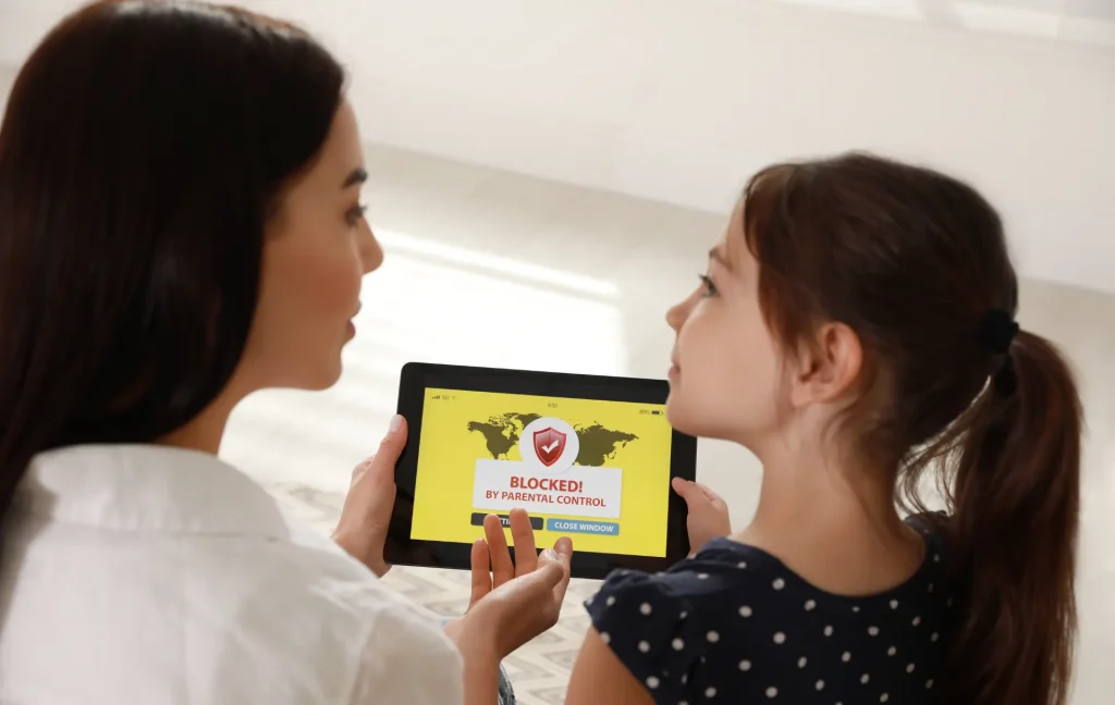 parent with kid at home with parental block on app on tablet