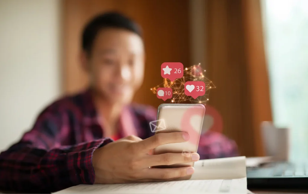 student on phone getting validation from social media follows and likes