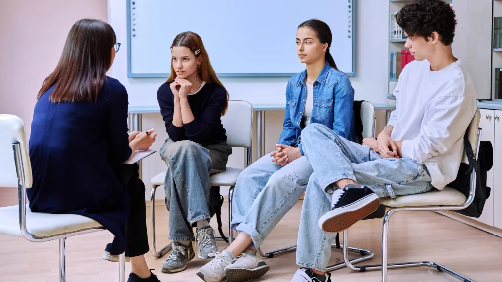 teacher/counsellor discussing common mental health disorders with students in class
